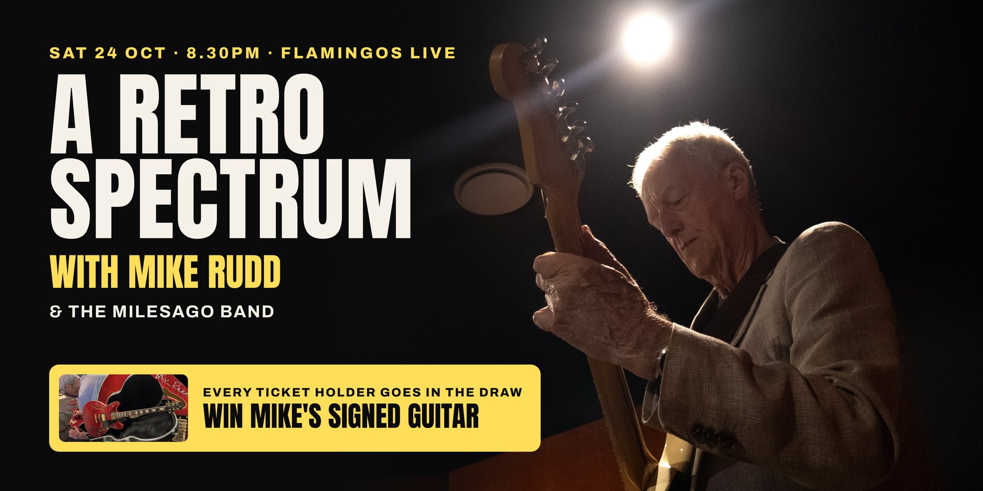Mike Rudd playing guitar under a spotlight. A Retro Spectrum with Mike Rudd, Sat 24 Oct, Flamingos Live. Every ticket holder goes in the draw to win Mike's signed guitar.
